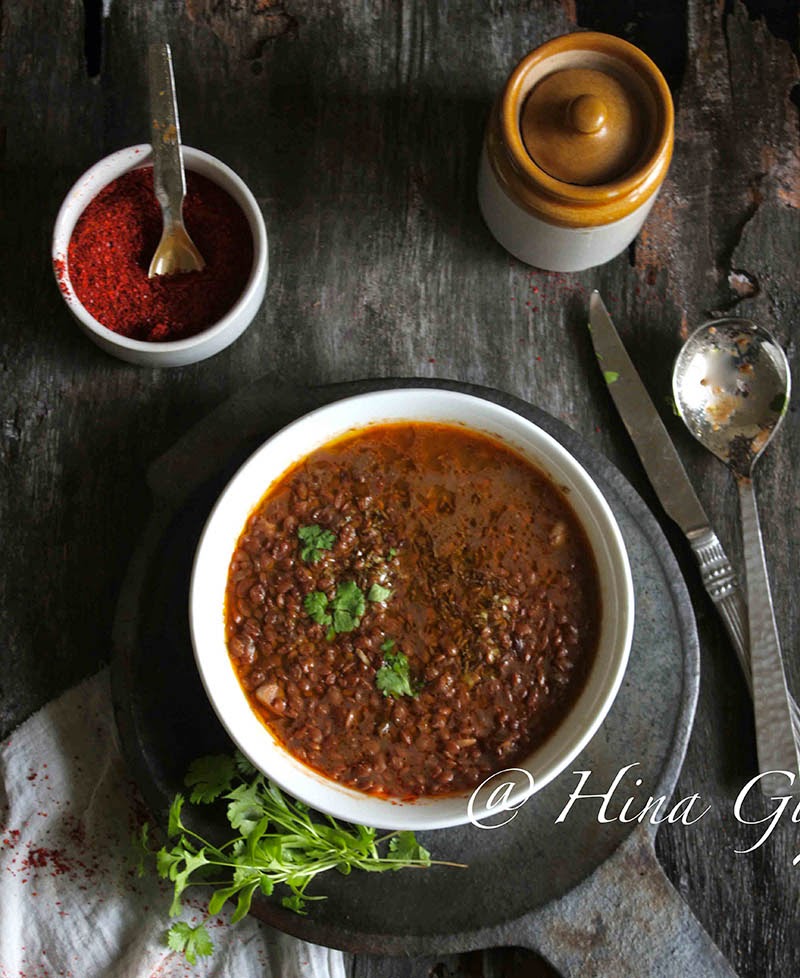 Aerial shot of Pahadi Gahat Ki Dal in a white serving bowl on a black surface.