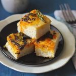 Gujarati Khatta Dhokla is steamed rice and lentil fudge seasoned with curry leaves, mustard seeds and red chili powder. Find recipe