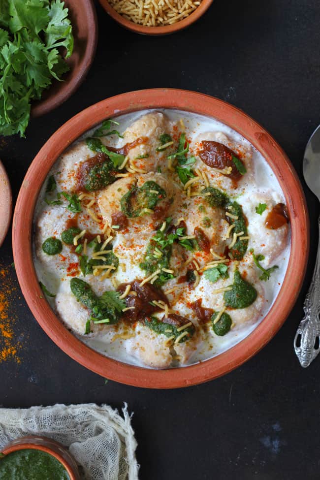 aerial shot of dahi vada served in an earthern pot