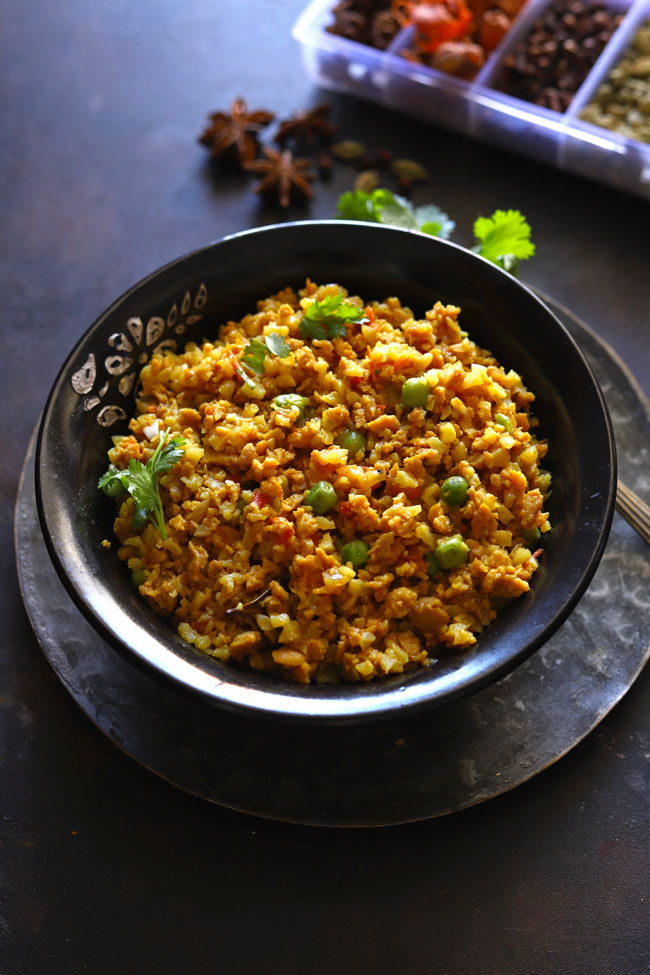 Side shot of vegetarian keema in a black serving bowl.