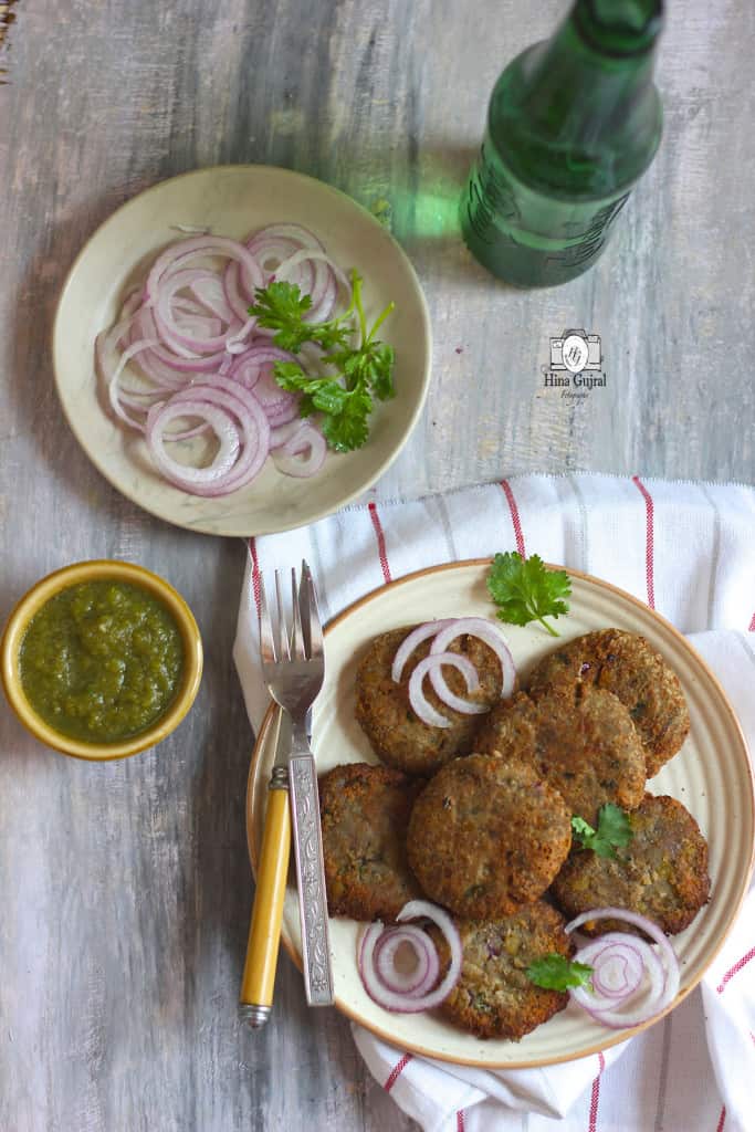 aerial shot of kelel ke kebab stacked on a cream platter