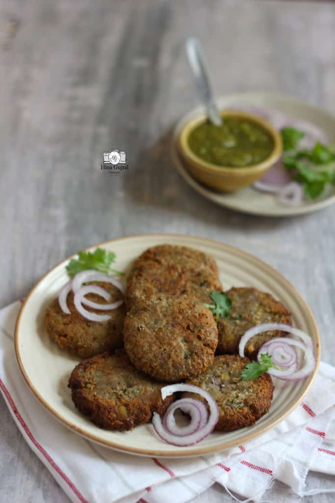 side close up shot of kele ke kebab stacked in a cream platter