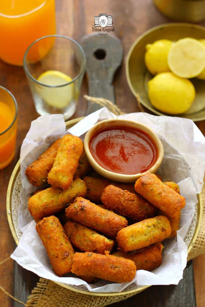 side shot of mixed vegetable cutlet along with ketchup in a bowl