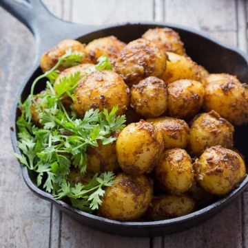 Bombay Potatoes Recipe (Masala Aloo) is the best ever Indian-style roasted potato recipe. Learn how to make Bombay Potatoes in few simple steps