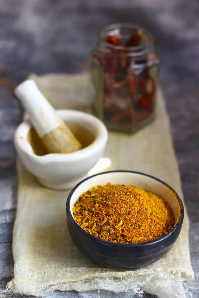 side shot of pickle masala in a black ceramic bowl