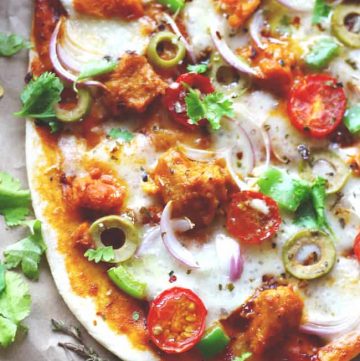 aerial shot of naan pizza on a brown parchment paper