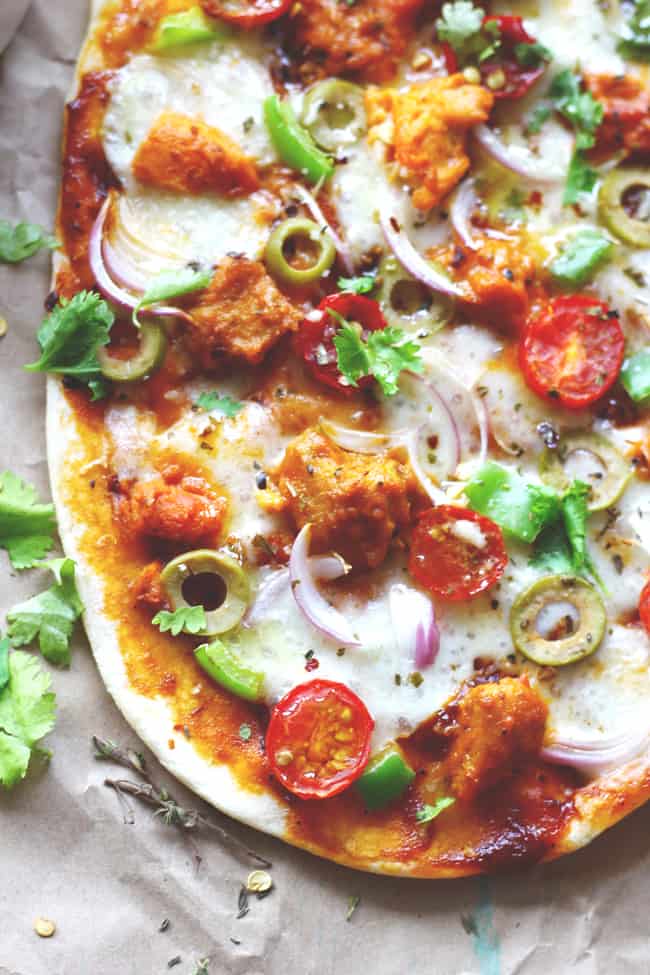 aerial shot of naan pizza on a brown parchment paper