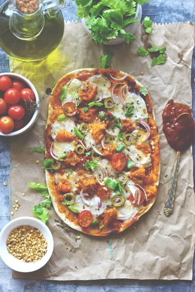 aerial shot of naan pizza on a brown parchment paper