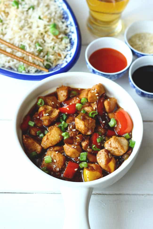 side shot of chicken kung pao served on a ceramic white platter