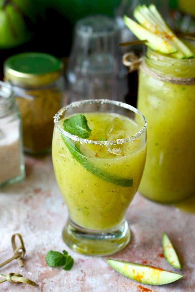 Side shot of mango panna in a glass garnished with mint leaves