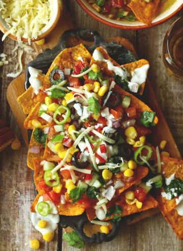 aerial shot of loaded veggies nachos on a platter