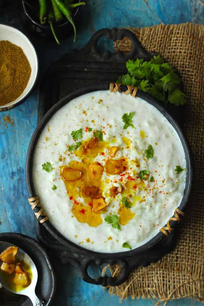 aerial shot of baingan ka raita on a black serving bowl