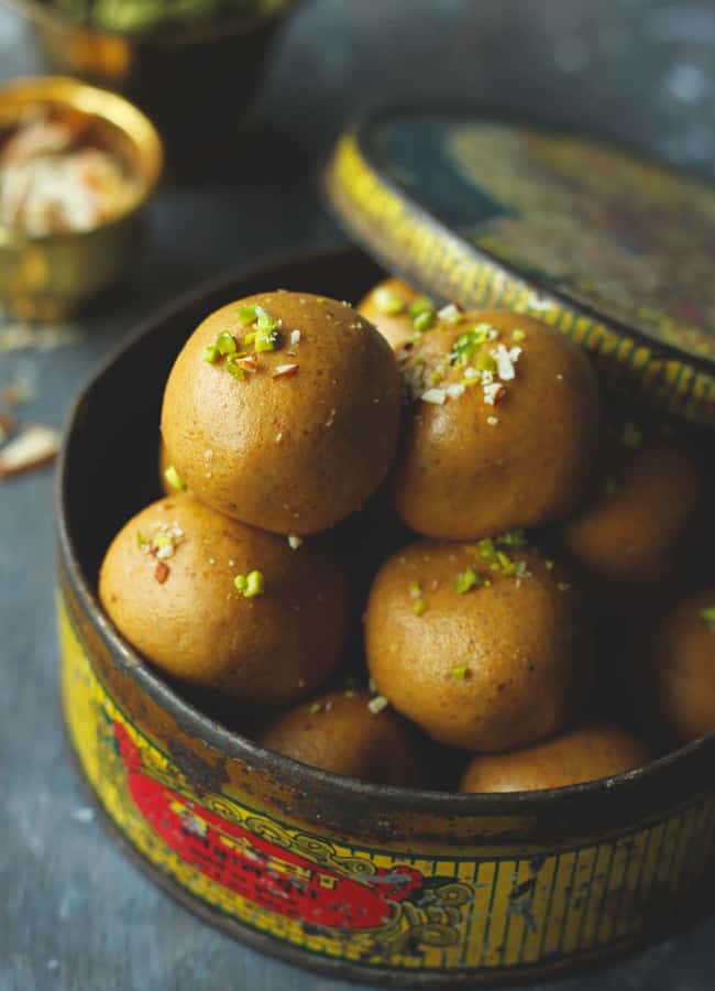 close up shot of besan ke ladoo in a vintage container