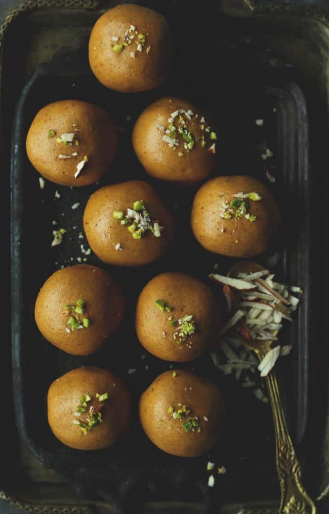 aerial shot of besan ladoo arranged on a black platter