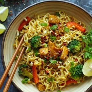 aerial shot of stir fry chicken maggi noodles in a ceramic bowl