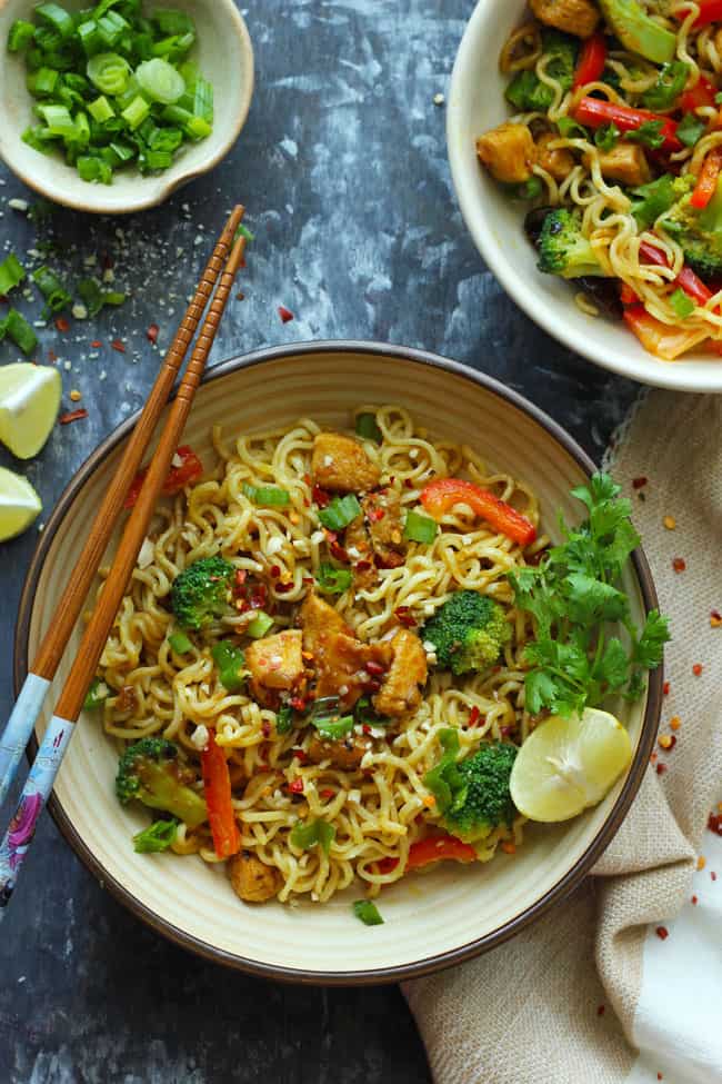 aerial shot of chicken Maggi in a ceramic bowl with chopsticks on the side