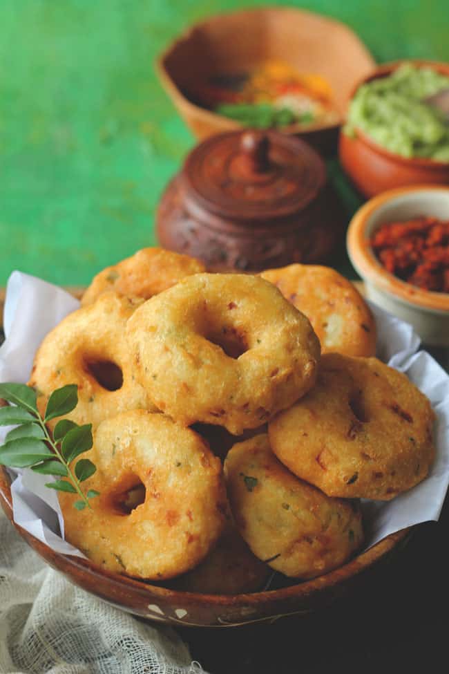 side close up shot of medu vada stacked on a bowl