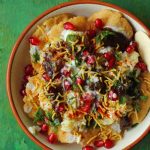 aerial shot of dahi papdi chaat in a cream color ceramic platter