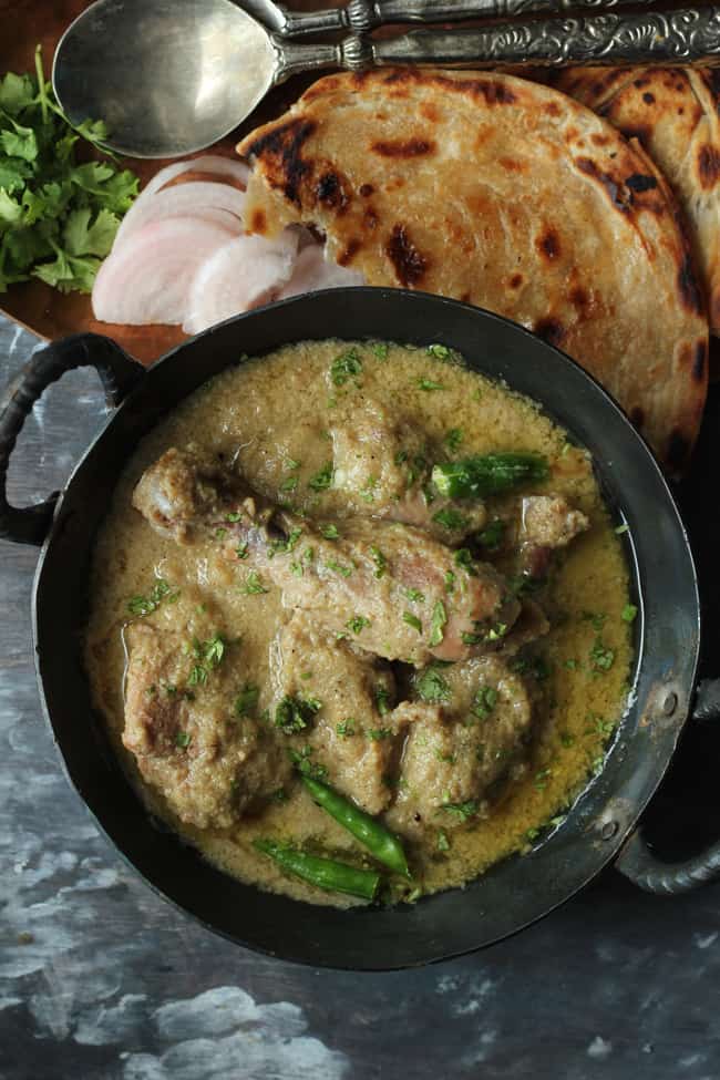 aerial shot of chicken korma curry in a black kadhai