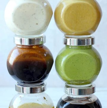 side shot of salad dressings stacked in glass jars