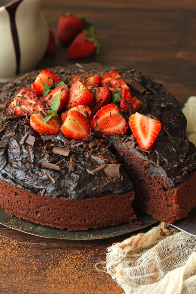 Eggless Chocolate Cake Decorated With Chocolate Frosting And Strawberries