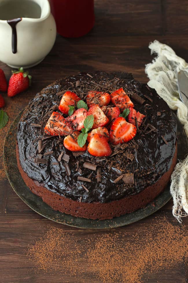 Eggless Chocolate Cake Decorated With Chocolate Frosting And Strawberries