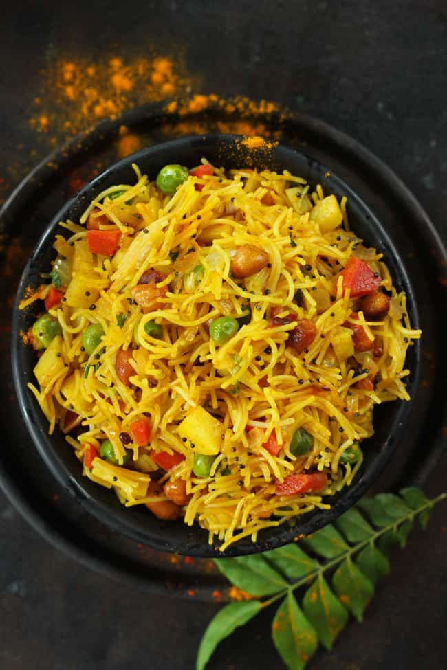 aerial shot of vermicelli upma in a black serving bowl