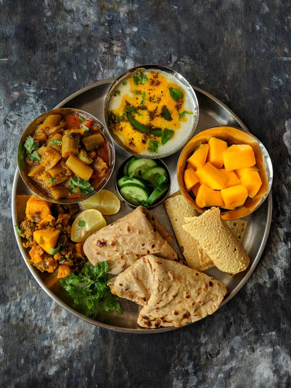 aerial shot of Indian thali meal on a black surface