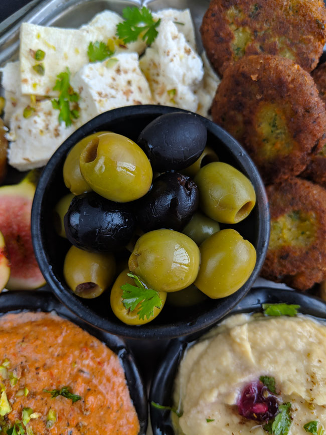 aerial shot of marinated olives in a Mediteranean appetizer platter