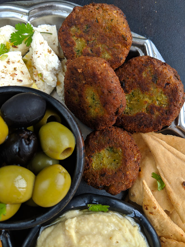 close up shot of falafel in a Mediterranean platter