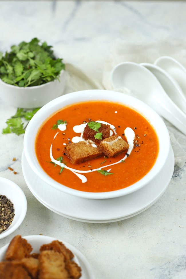 side aerial shot of tomato soup in a white serving bowl