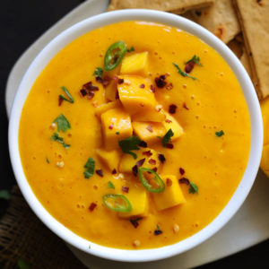Aerial Shot Of Spicy Mango Dip Garnished With Chopped Mangoes In A White Bowl