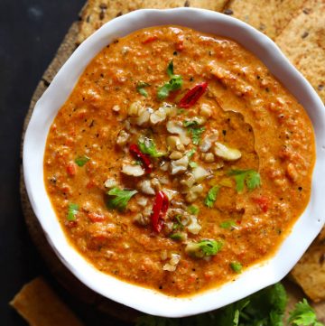 aerial shot of roasted red pepper dip in a white ceramic bowl