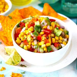 side shot of corn salsa in a white ceramic bowl