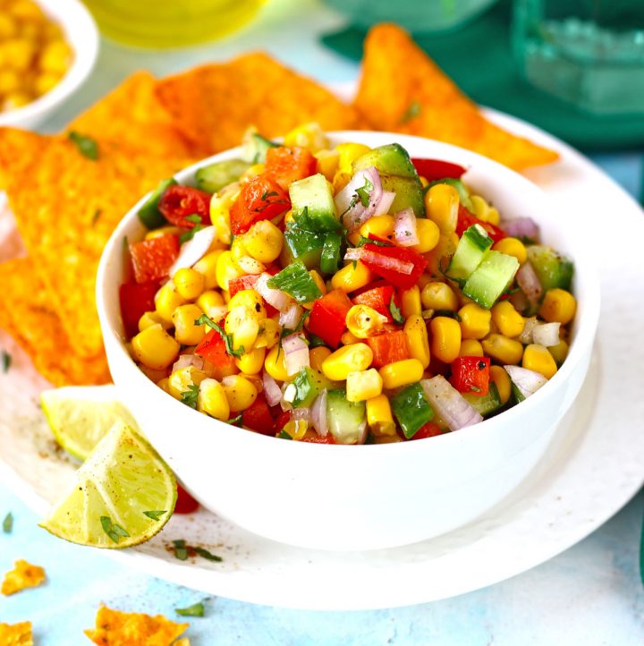 side shot of corn salsa in a white ceramic bowl