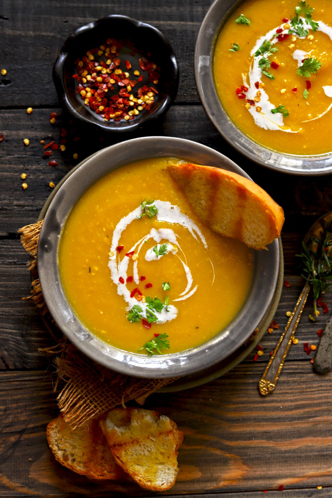 aerial shot of pumpkin soup in a grey ceramic bowl