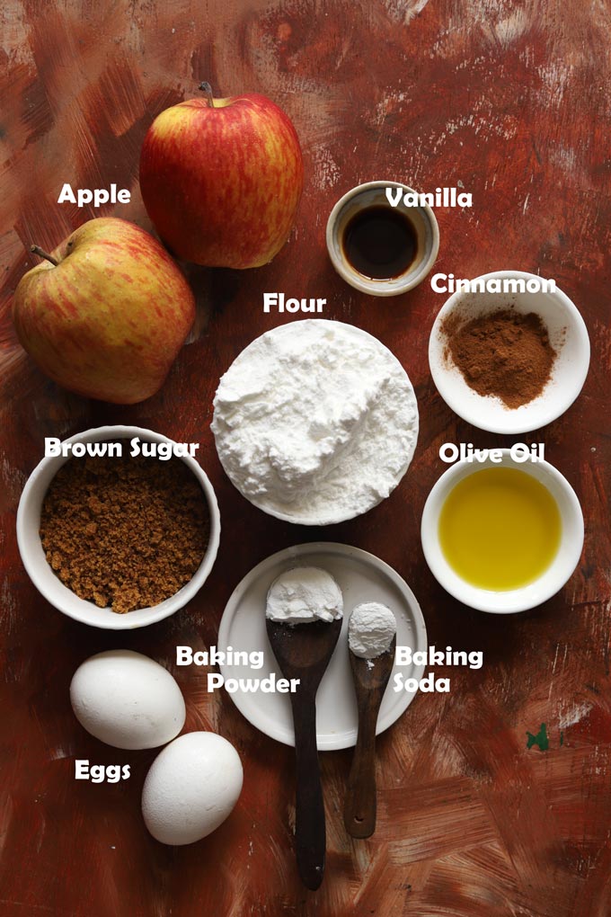 Ingredients - flour, brown sugar, apples, eggs, olive oil, cinnamon powder, baking soda, baking powder for apple muffins. 