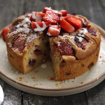 Sliced Fresh Strawberry Cake Topped With Strawberry Slices And Cream