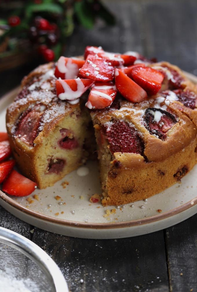 Sliced Fresh Strawberry Cake Topped With Strawberry Slices And Cream