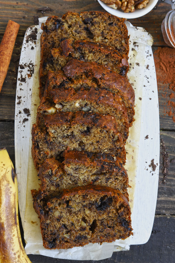 Aerial shot of eggless banana bread slices on a white platter.