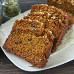 Side shot of eggless whole wheat cake slices in a white platter.