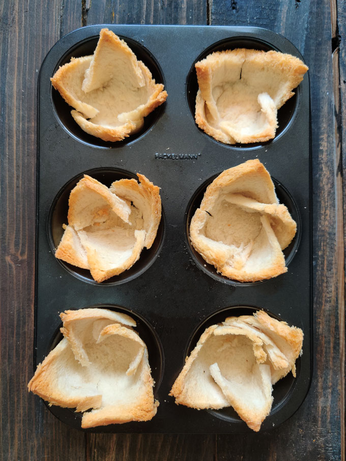 Aerial shot of Baked Bread basket in a black muffin tray.