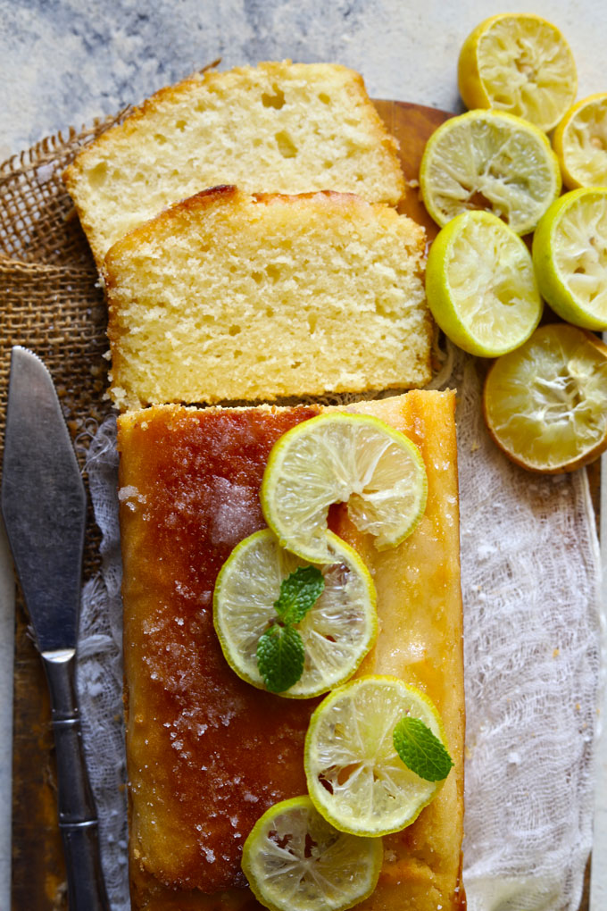 Aerial shot of sliced pound cake loaf garnished with lemon.