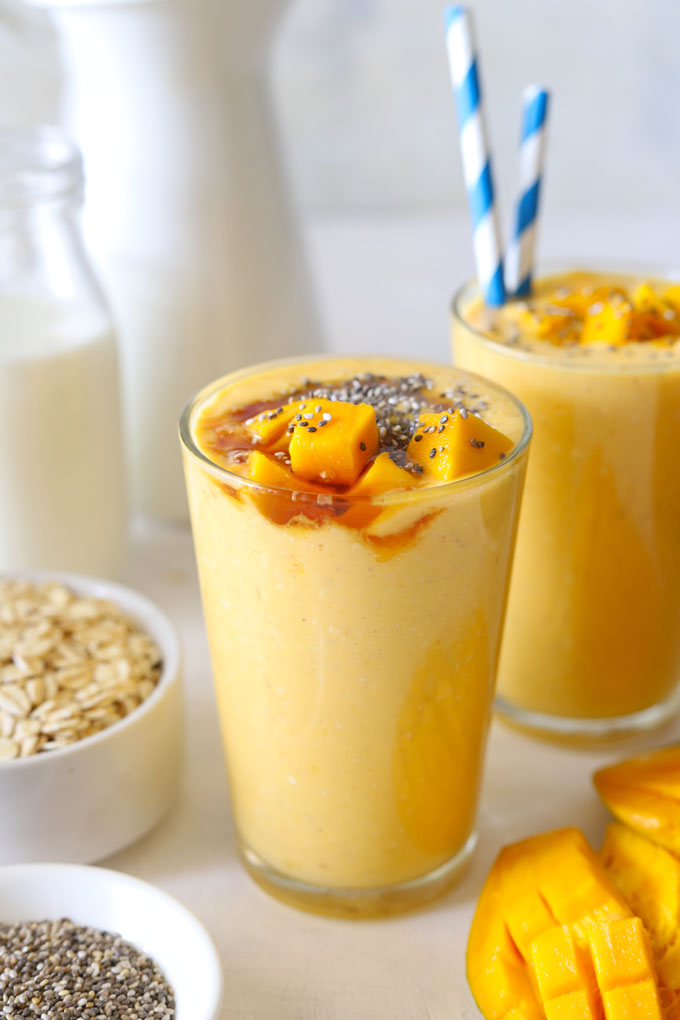 Side shot of mango oats smoothie in a glass.