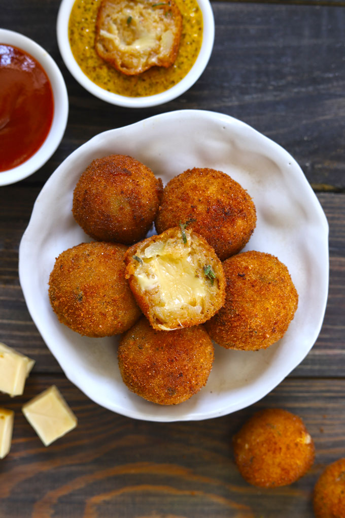 Aerial shot of cheese balls stacked in a white platter.