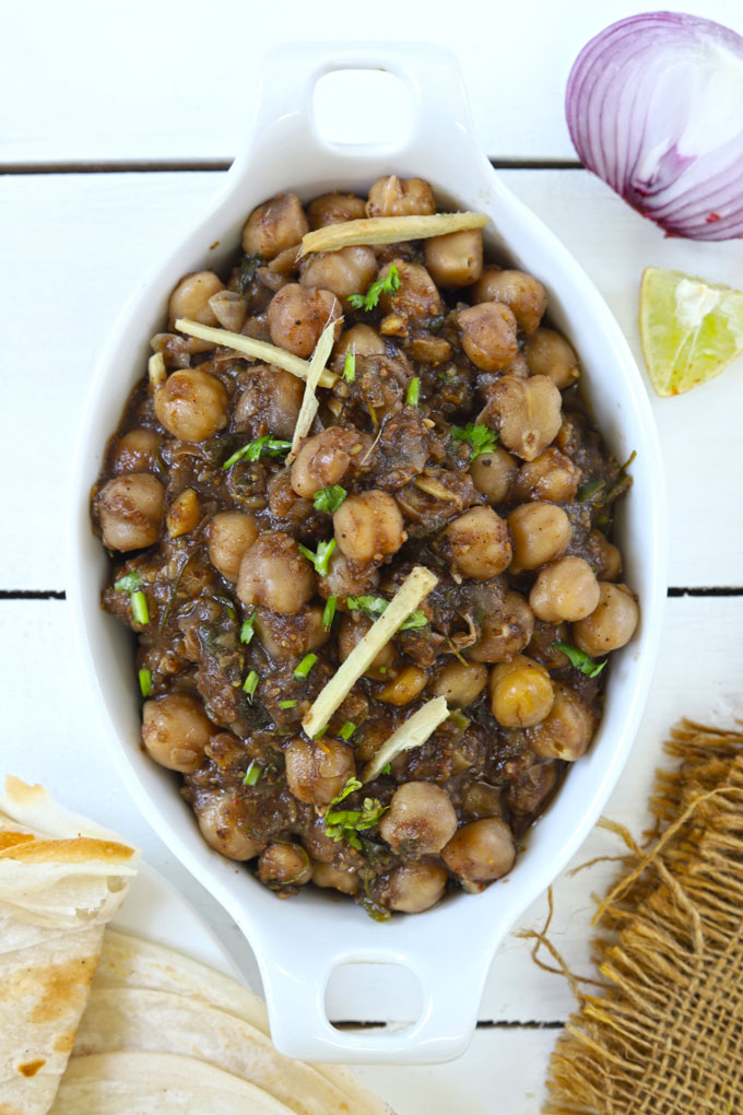 Aerial shot of Indian chole in an oval white serving bowl