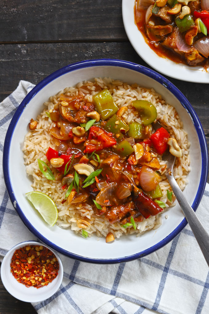 aerial shot of chilli mushroom gravy with fried rice on a white serving bowl