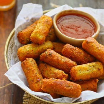 side shot of mixed vegetable cutlet along with ketchup in a bowl