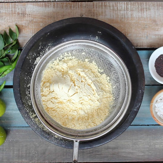 Sifting gram flour for dhokla