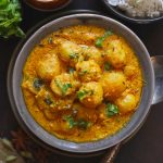 aerial shot of dum aloo in a grey ceramic serving bowl